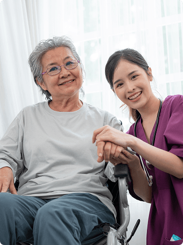 A carer smiling warmly with an older client