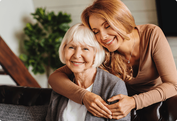 Two women smiling warmly together while talking through a plan